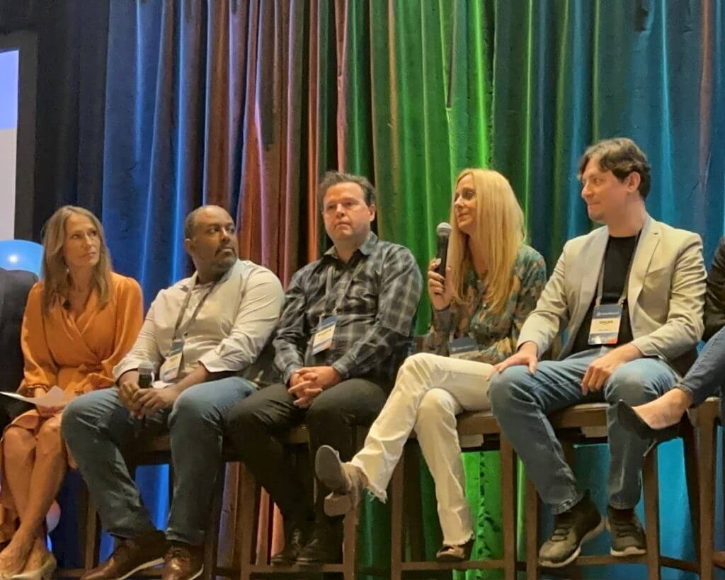 RealWealth members Malcolm and Merry talk on a member panel at a RealWealth real estate investing event.