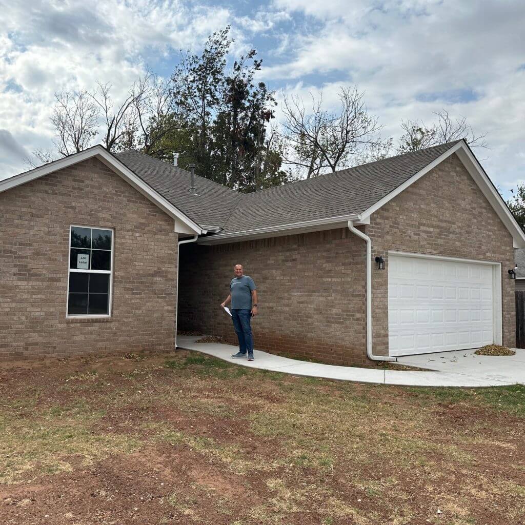 Grant Anderson at RealWealth standing in front of an investment property.