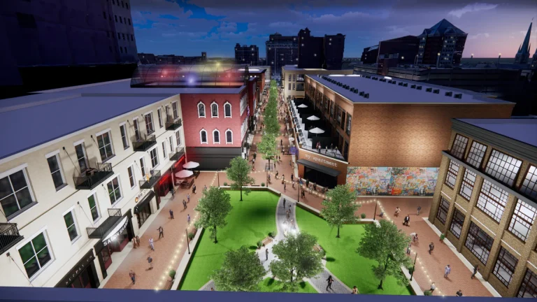 A rendering of the Circle Center Mall redevelopment, showing an aerial view of people walking through a plaza with a park and retail space.