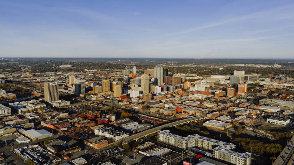 Aerial photograph showcasing Birmingham, Alabama's urban skyline and city layout.